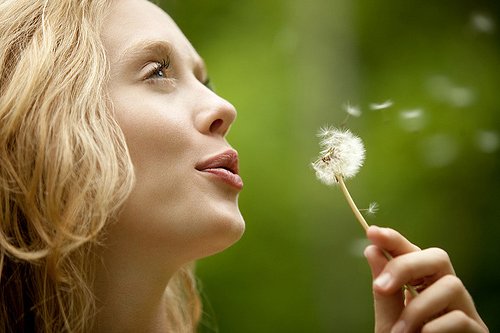 woman-blowing-dandelion