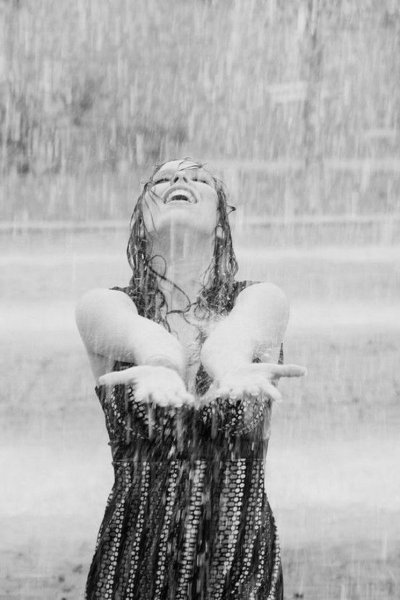 black-and-white-image-of-woman-standing-in-the-rain